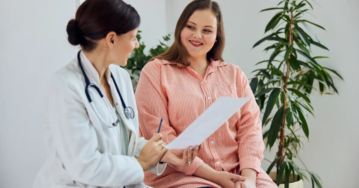 Provider measuring a patient's waist during a medical weight loss consultation at iCRYO New Braunfels