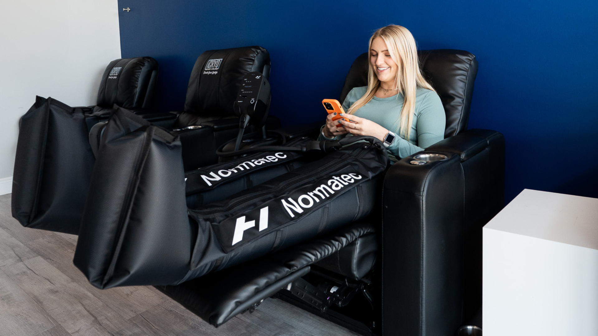 Patient using NormaTec compression therapy boots
