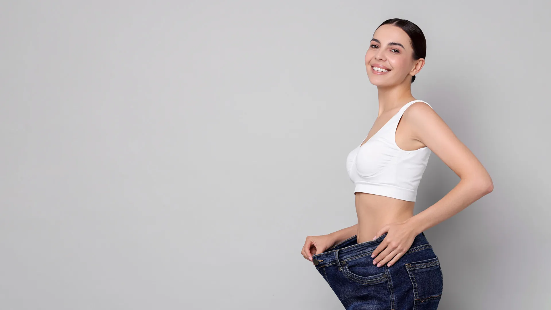Woman celebrating weight loss results at iCRYO New Braunfels Medical Weight Loss program